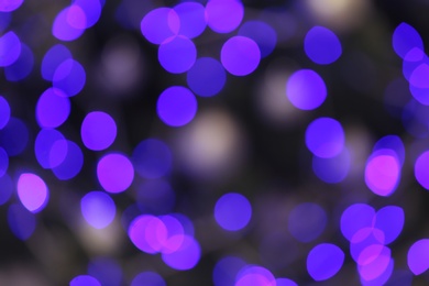 Photo of Blurred view of glowing Christmas lights as background. Festive mood