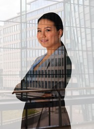 Double exposure of businesswoman and cityspace with office buildings