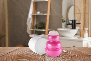 Image of Roll-on deodorant on wooden table in bathroom