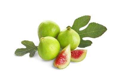 Whole and cut green figs on white background