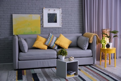 Photo of Stylish living room interior with comfortable sofa