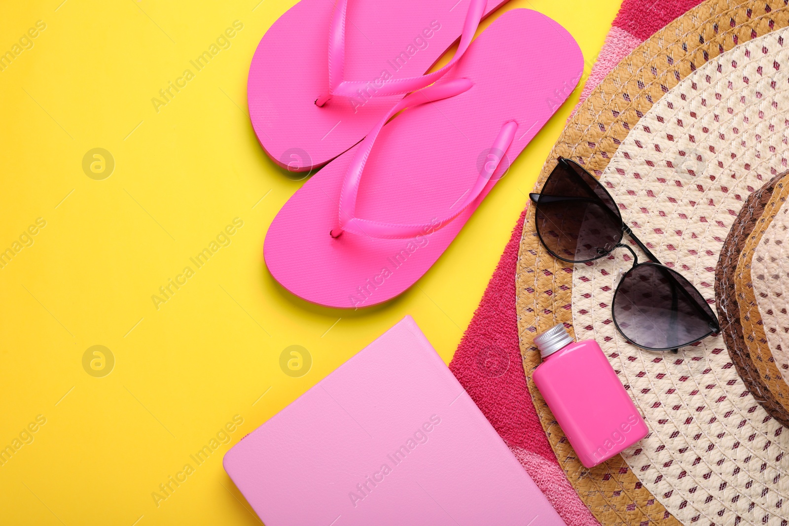 Flat lay composition with beach accessories on yellow background. Space for text Photo of Flat lay composition with beach accessories on yellow background. Space for text