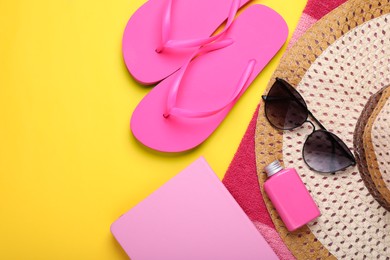 Photo of Flat lay composition with beach accessories on yellow background. Space for text