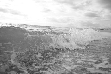 Image of Sea waves rolling onto tropical beach, toned in black and white
