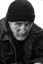 Photo of Portrait of poor homeless man with hat outdoors