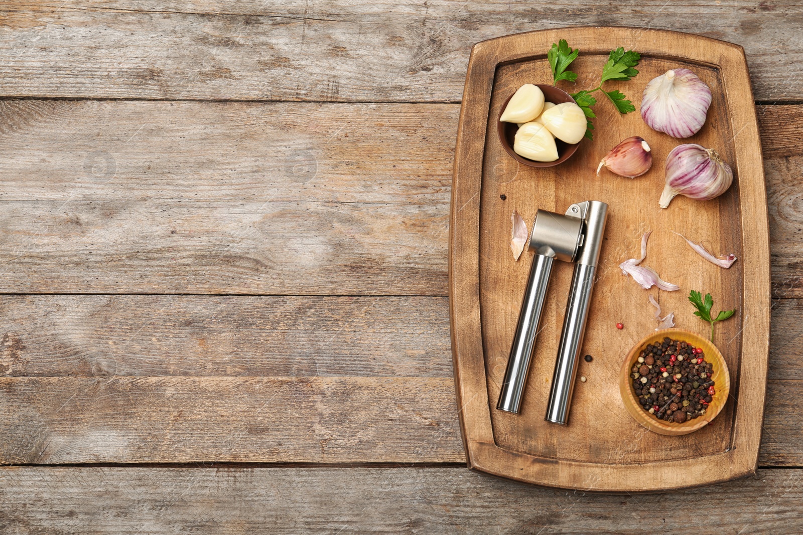 Photo of Flat lay composition with garlic press on wooden table