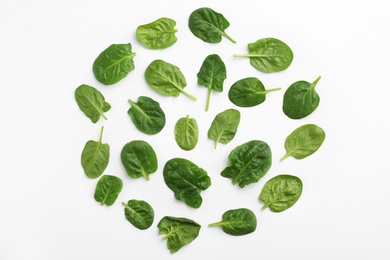 Photo of Fresh leaves of spinach isolated on white, top view