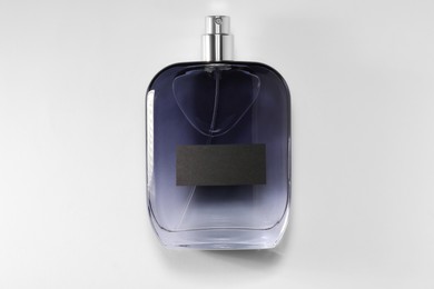 Luxury men`s perfume in bottle on white background, top view