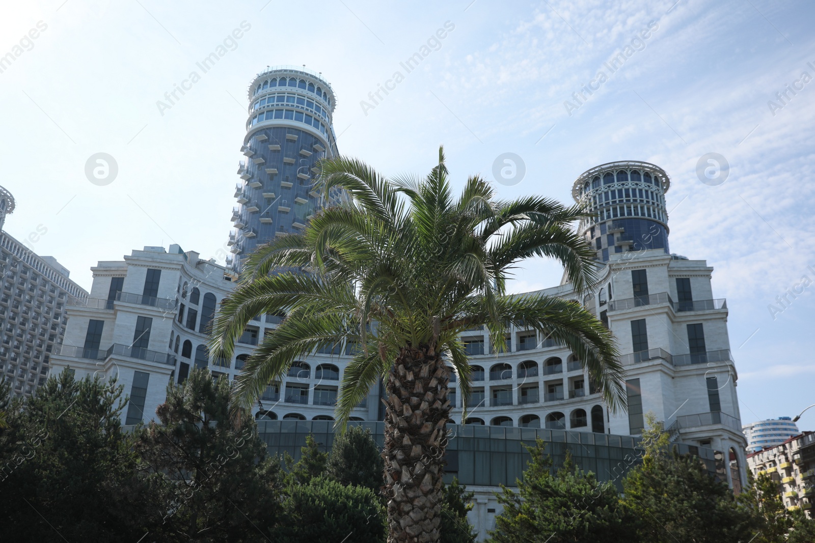 Photo of BATUMI, GEORGIA - JUNE 10, 2022: Beautiful view of Sea Towers Suit hotel and palm trees outdoors