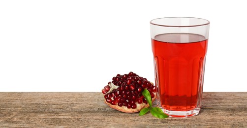 Photo of Refreshing pomegranate juice in glass, leaves and fruit on wooden table against white background. Space for text