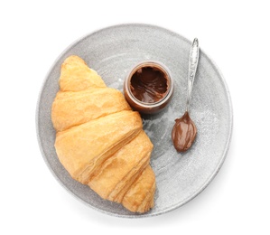 Photo of Plate with tasty croissant and chocolate sauce on white background, top view