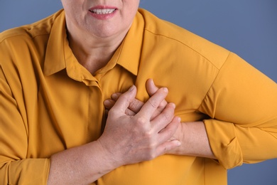 Mature woman having heart attack, closeup