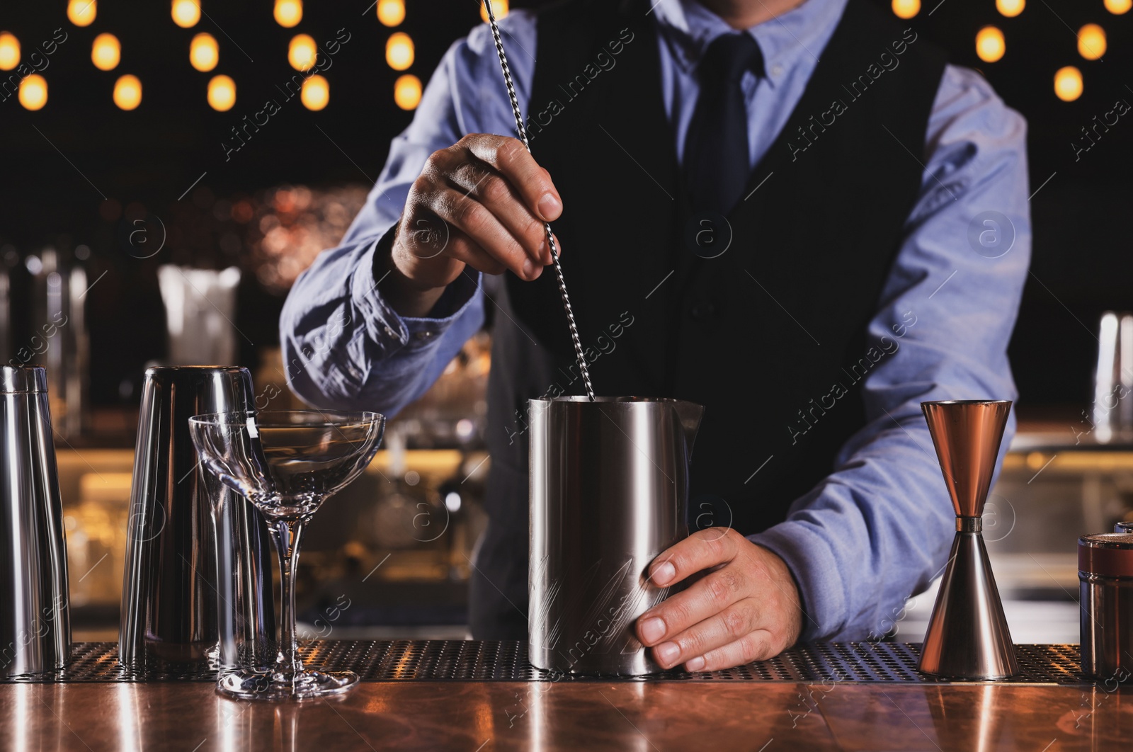 Photo of Bartender preparing fresh alcoholic cocktail in bar, closeup