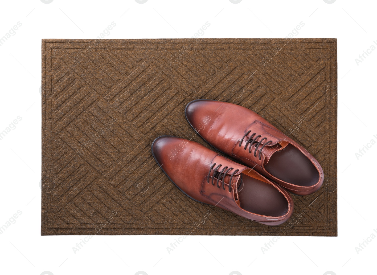 Photo of New clean door mat with shoes on white background, top view