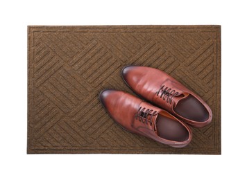 Photo of New clean door mat with shoes on white background, top view