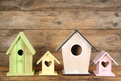 Collection of handmade bird houses on wooden table