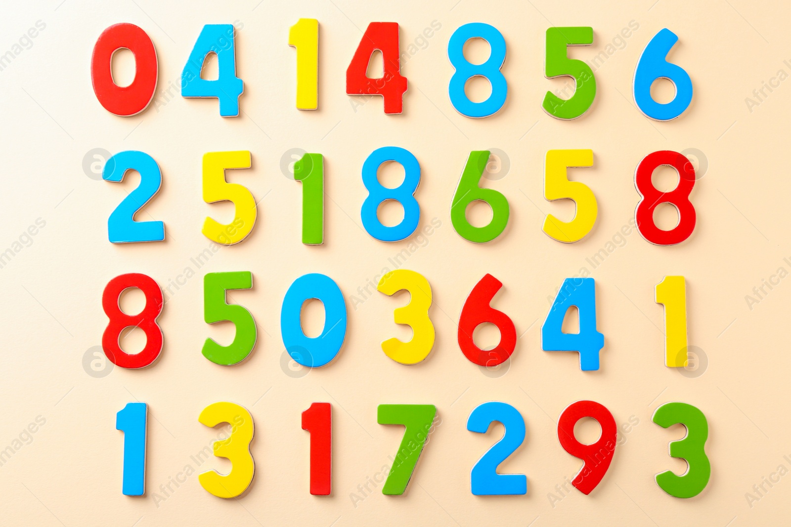 Photo of Colorful numbers on beige background, flat lay