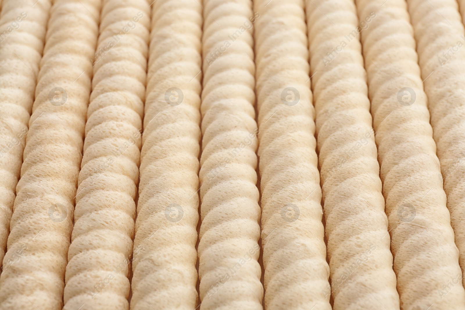 Photo of Delicious wafer rolls as background, closeup. Sweet food