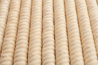 Photo of Delicious wafer rolls as background, closeup. Sweet food