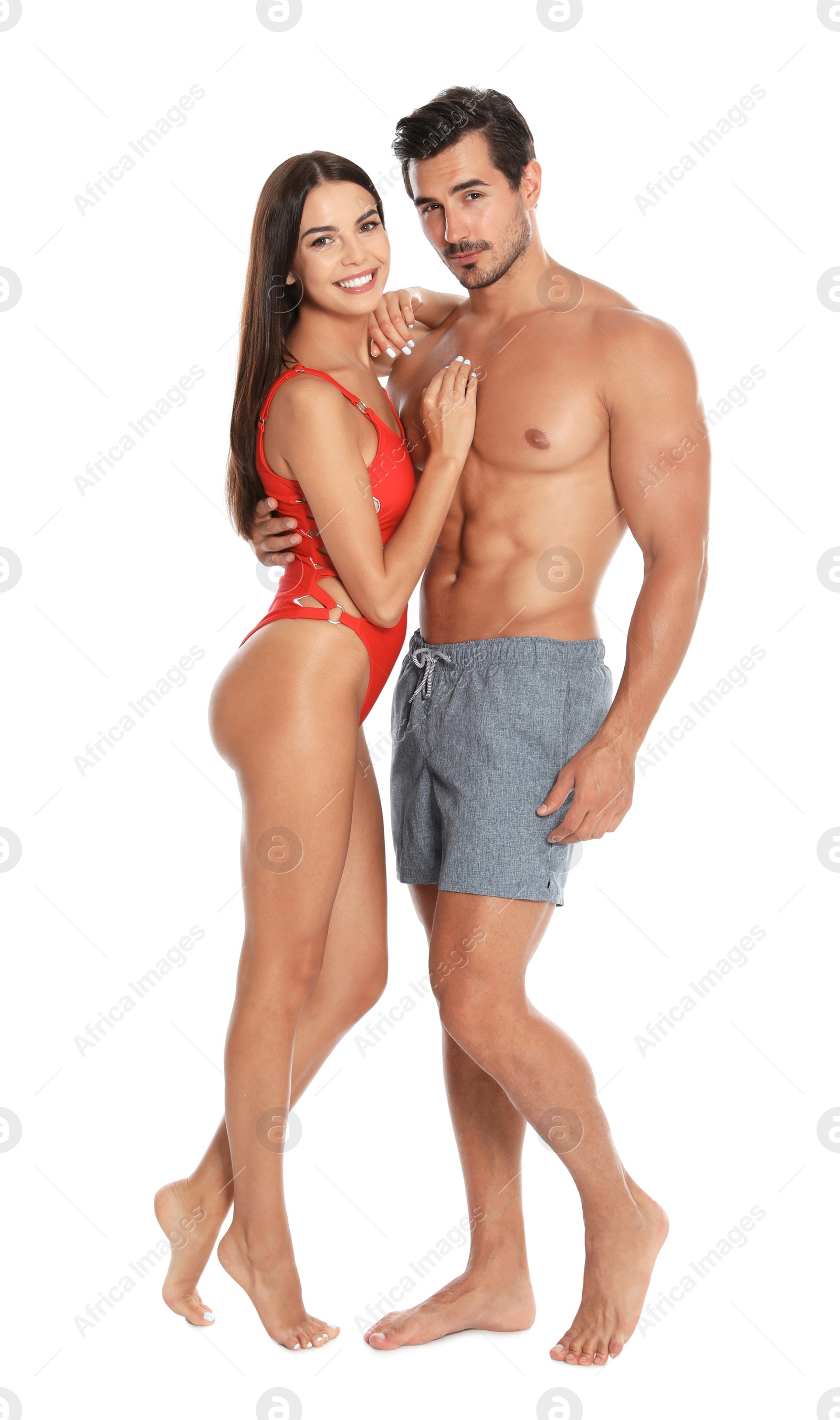 Photo of Young attractive couple in beachwear on white background