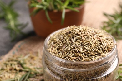 Photo of Closeup view of jar with dry rosemary