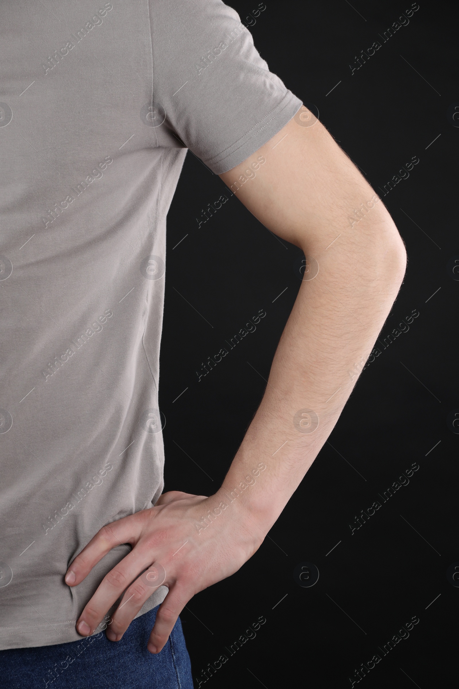 Photo of Man with space for tattoo on his arm against black background, closeup