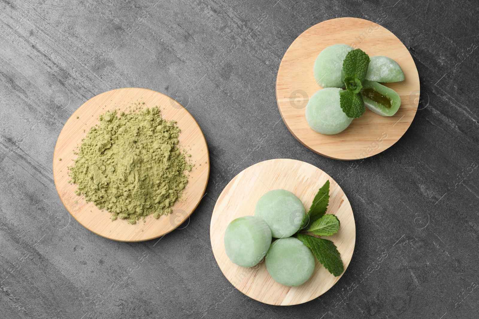 Photo of Delicious matcha mochi on grey table, flat lay