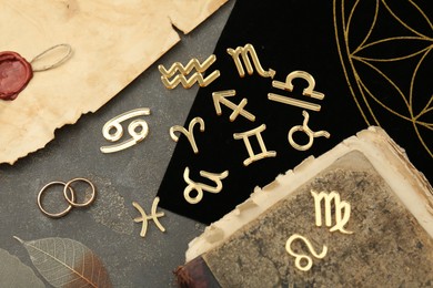 Photo of Flat lay composition with zodiac signs on grey textured table