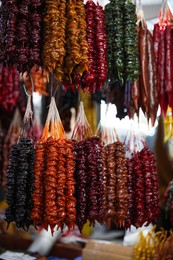 Photo of Bunches of different delicious churchkhelas at market