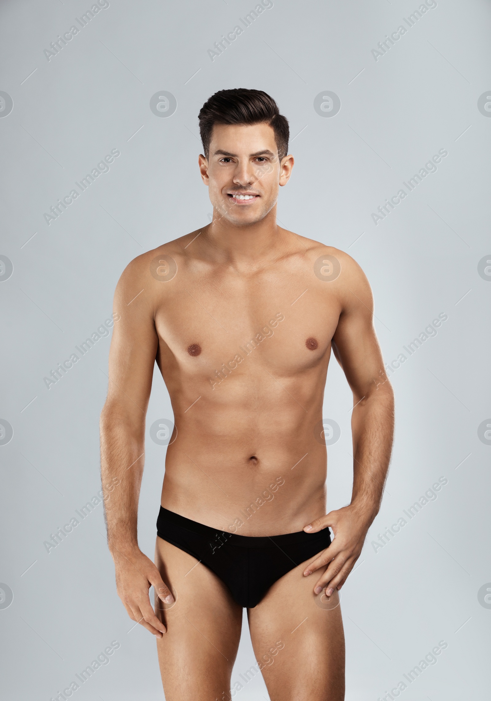 Photo of Handsome man in black underwear on light grey background