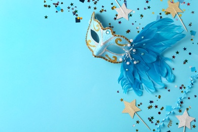 Photo of Beautiful carnival mask with decor on light blue background, flat lay. Space for text