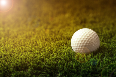 Image of Golf ball in park on sunny day. Space for design