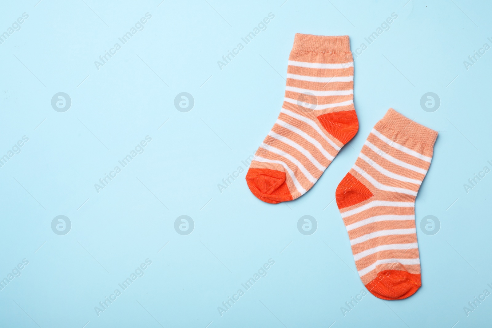 Photo of Cute child socks on color background, flat lay. Space for text