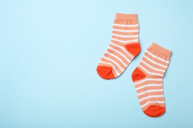 Cute child socks on color background, flat lay. Space for text