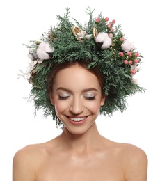 Happy young woman wearing wreath on white background