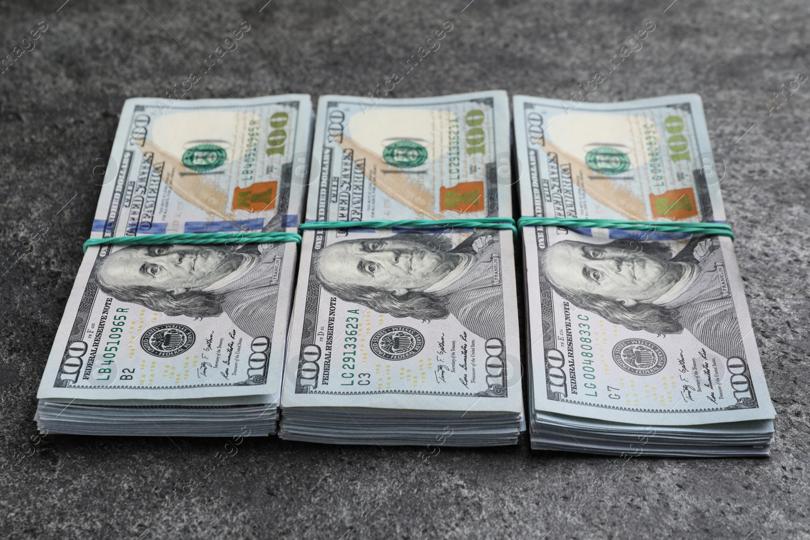 Photo of Many dollar banknotes on grey table. American national currency