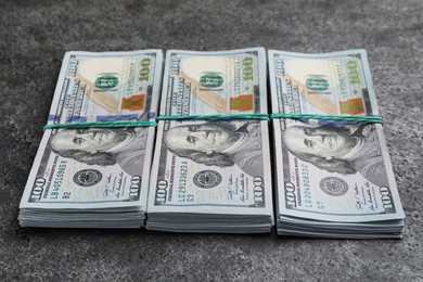 Photo of Many dollar banknotes on grey table. American national currency