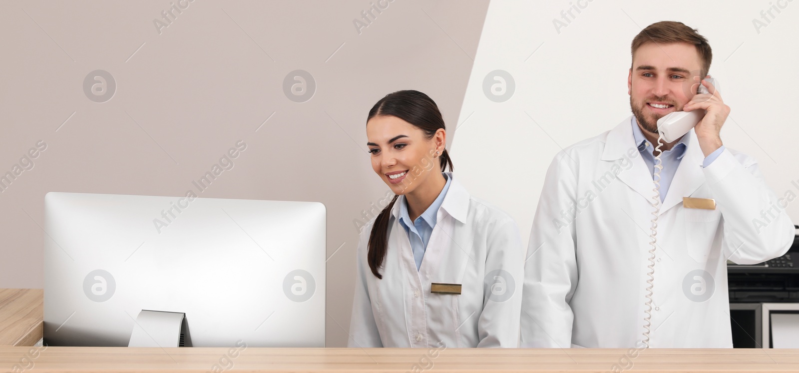 Image of Professional staff working at reception in modern clinic. Banner design