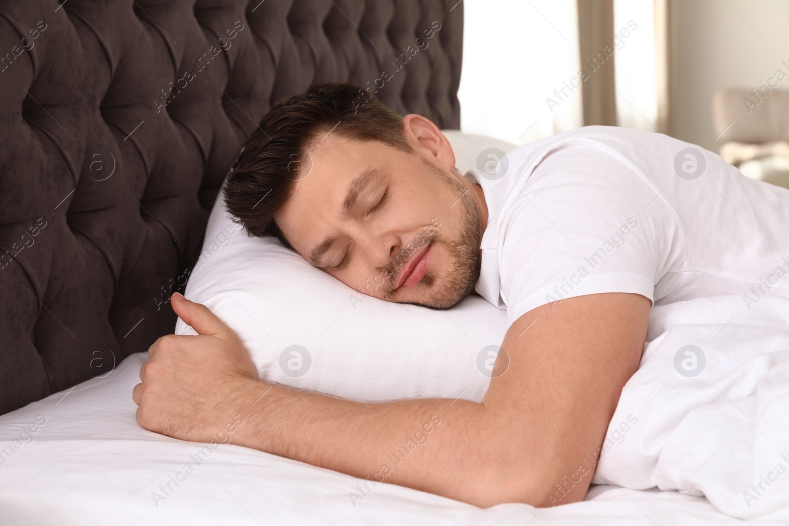 Photo of Handsome man sleeping on pillow at home. Bedtime