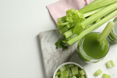 Photo of Glass of delicious celery juice and vegetables on white table, flat lay. Space for text