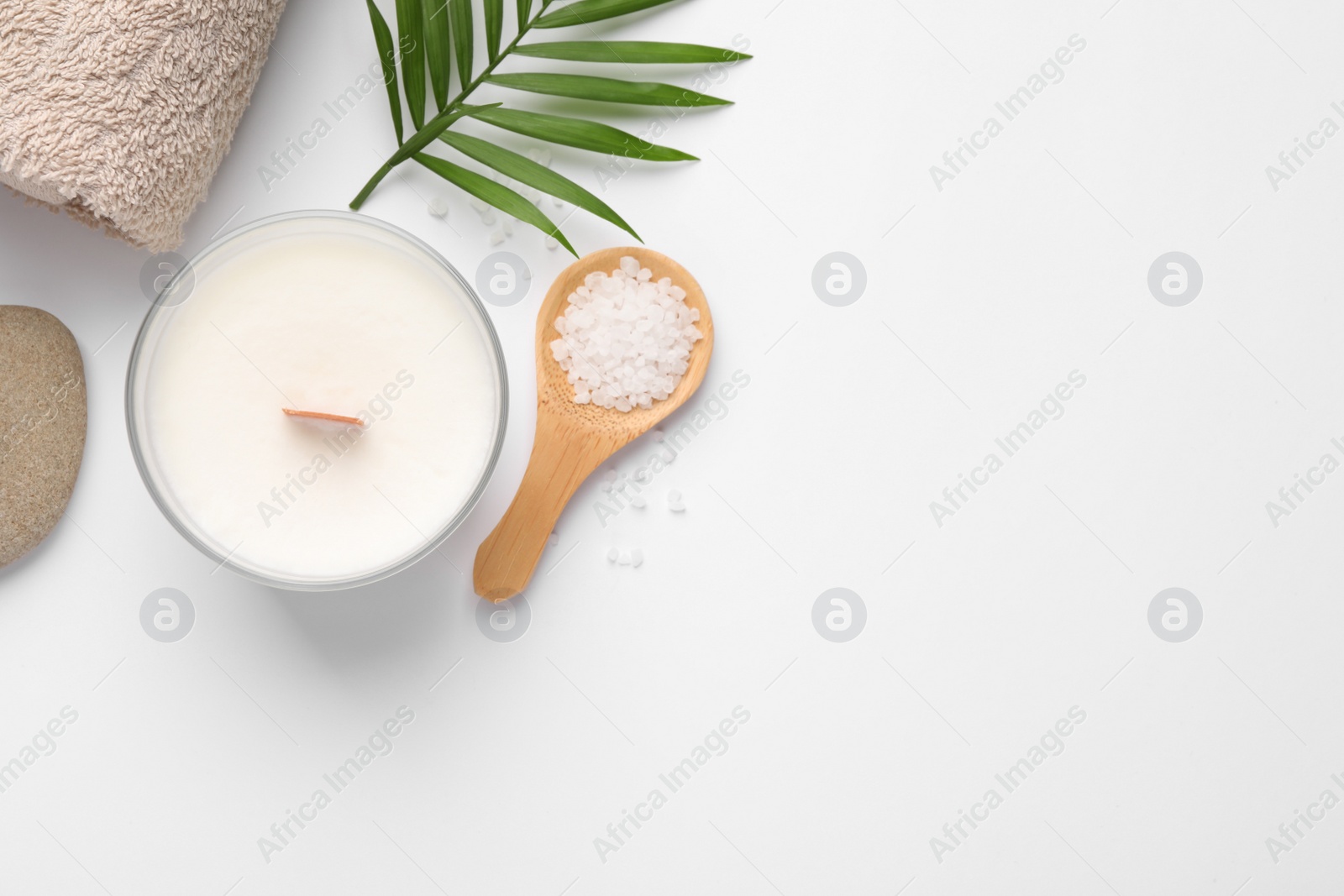 Photo of Flat lay composition with candle and different spa products on white background. Space for text