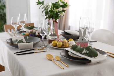 Beautiful Easter table setting with festive decor indoors