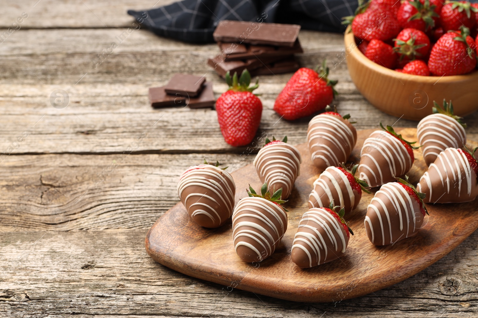 Photo of Delicious chocolate covered strawberries on wooden table. Space for text