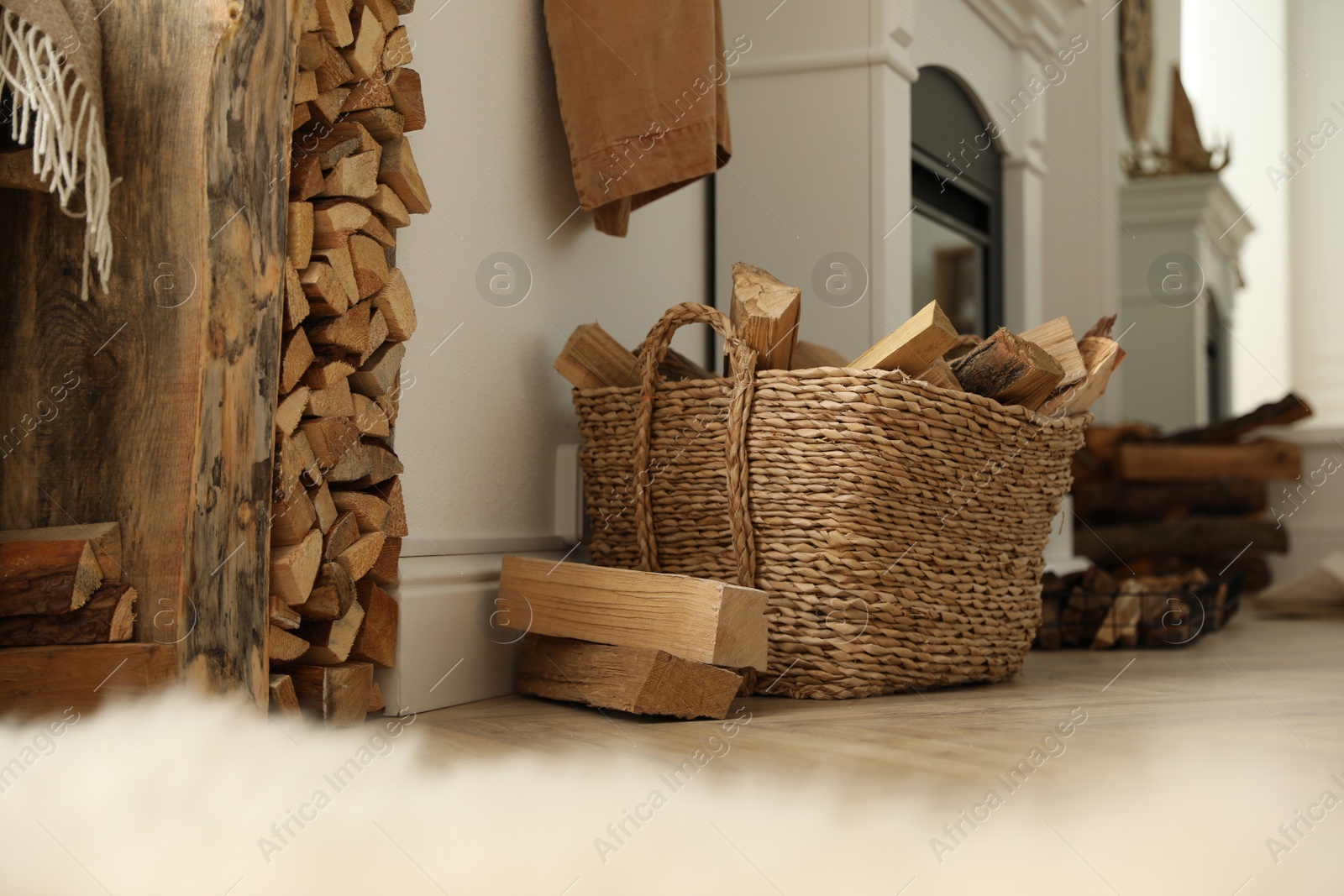 Photo of Basket with firewood on floor in room