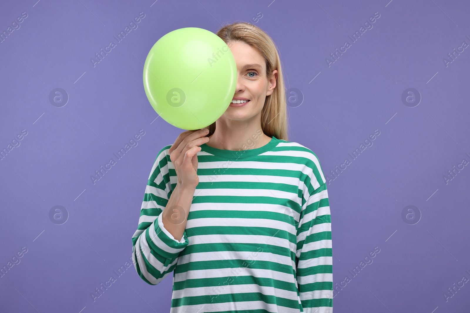 Photo of Woman with air balloon on violet background