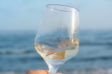 Photo of Glasstasty wine near sea, closeup