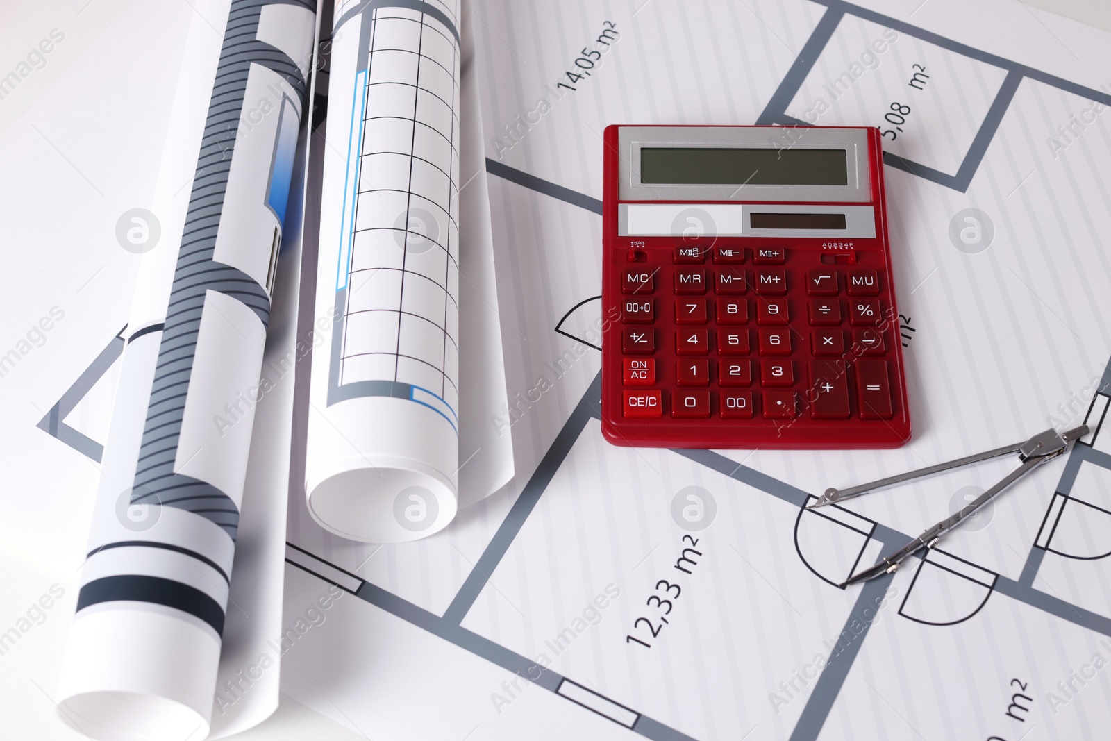 Photo of Construction drawings, calculator and dividers, closeup view