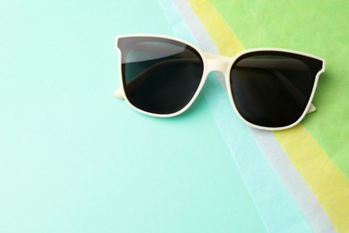 Photo of Stylish sunglasses on color background, top view. Space for text