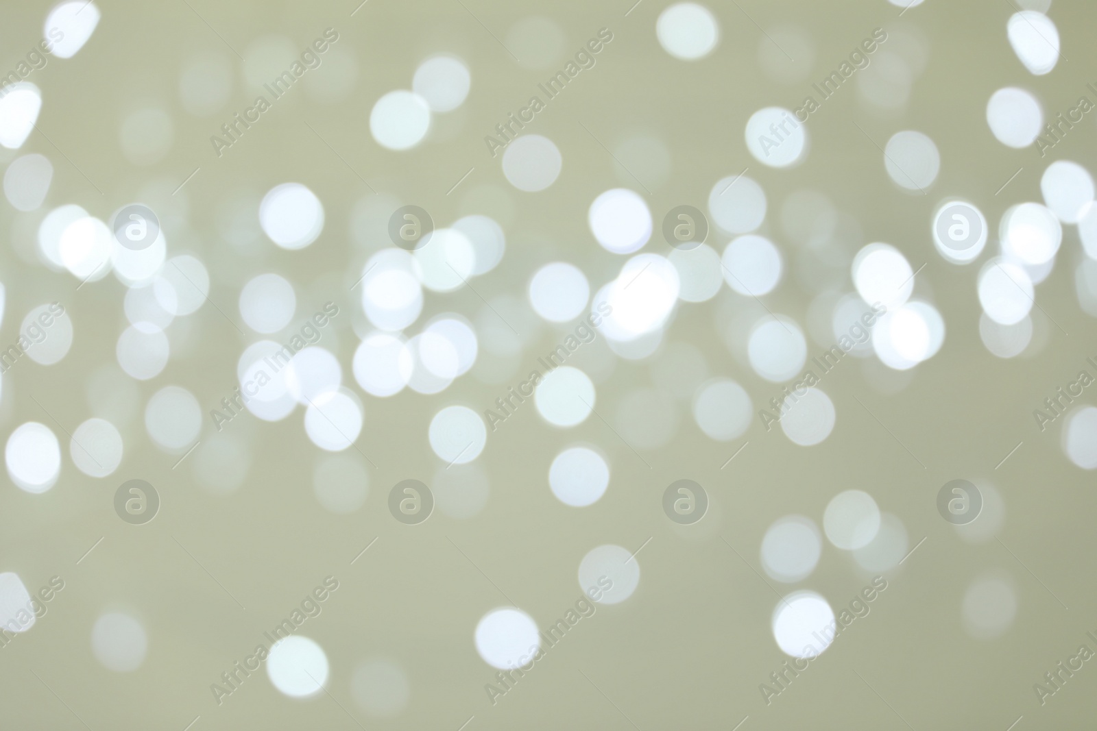 Photo of Blurred view of shiny silver lights. Bokeh effect