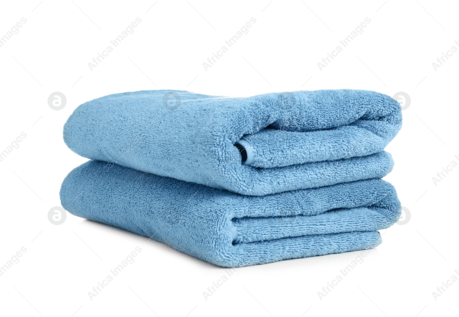 Photo of Folded soft terry towels on white background